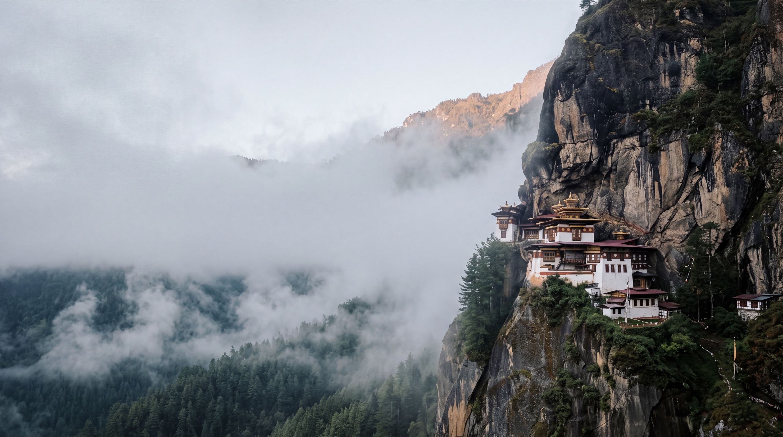 Paro Taktsang, the Tiger's Nest monastery, clinging to a misty cliff at dawn in Bhutan