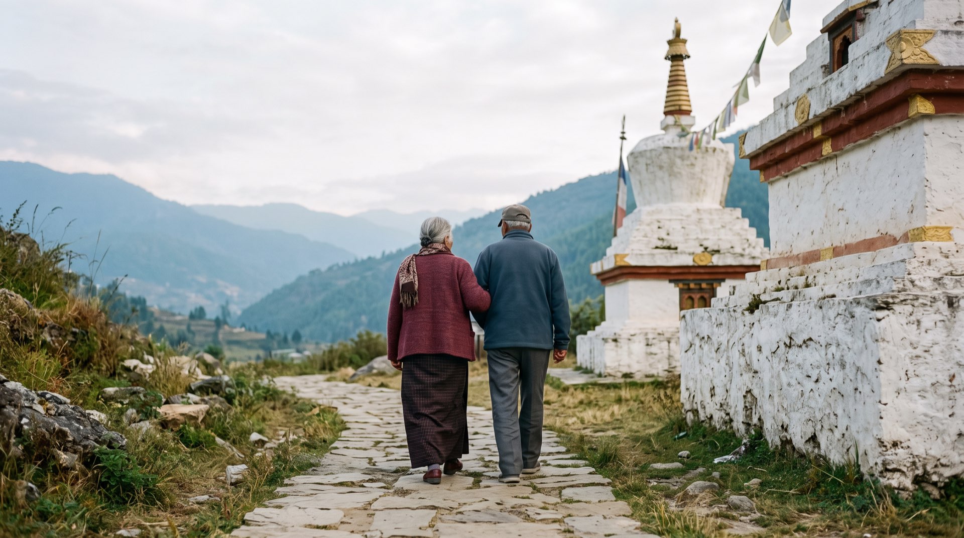 An older couple walking slowly beside a chorten
