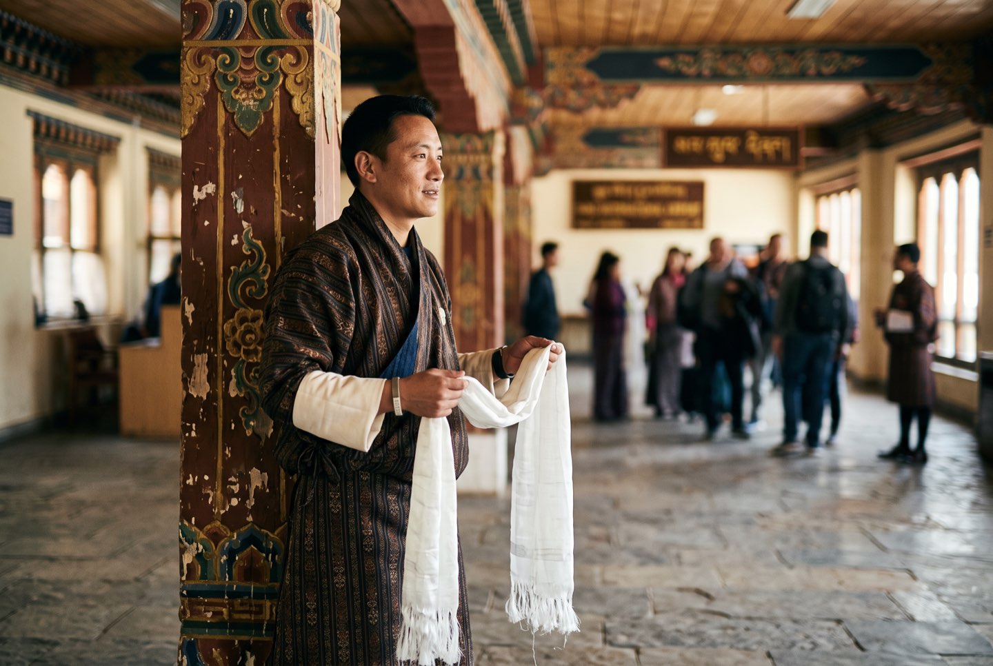A guide waiting with a welcome scarf