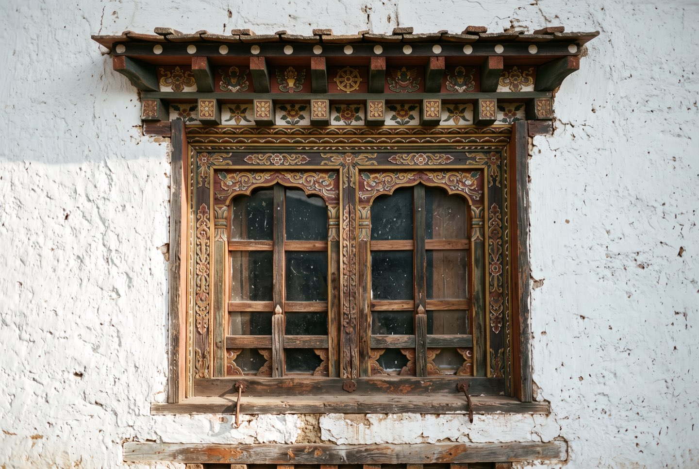 Painted window frames on a whitewashed wall