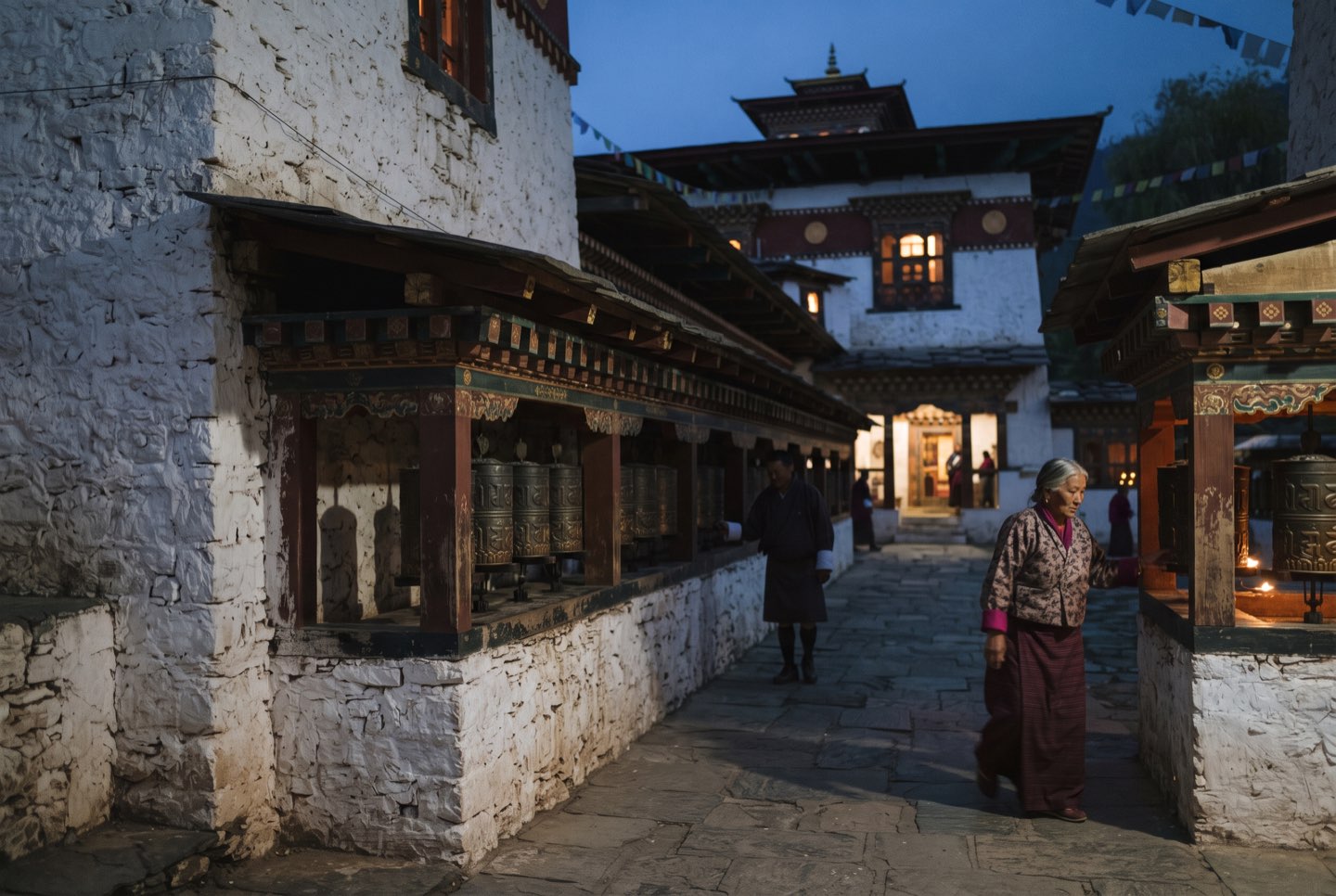 Jambay Lhakhang at dusk with pilgrims turning wheels